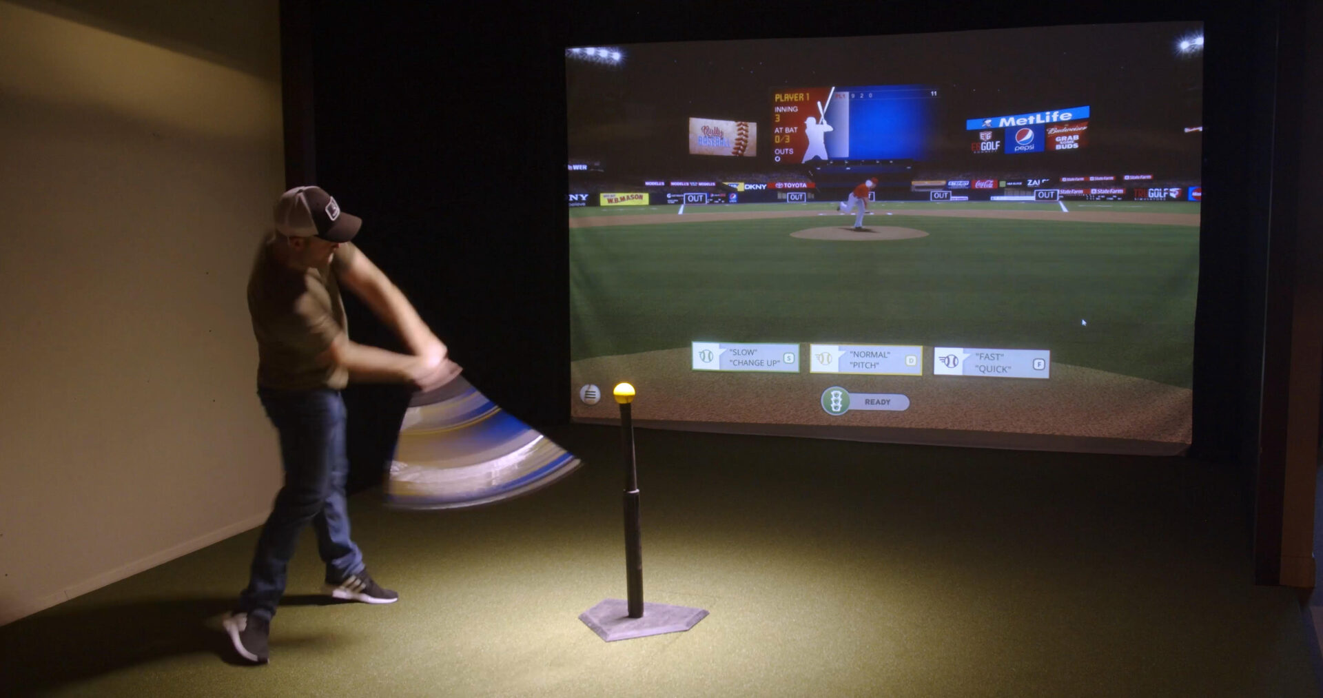 A man is playing baseball in a virtual reality room.