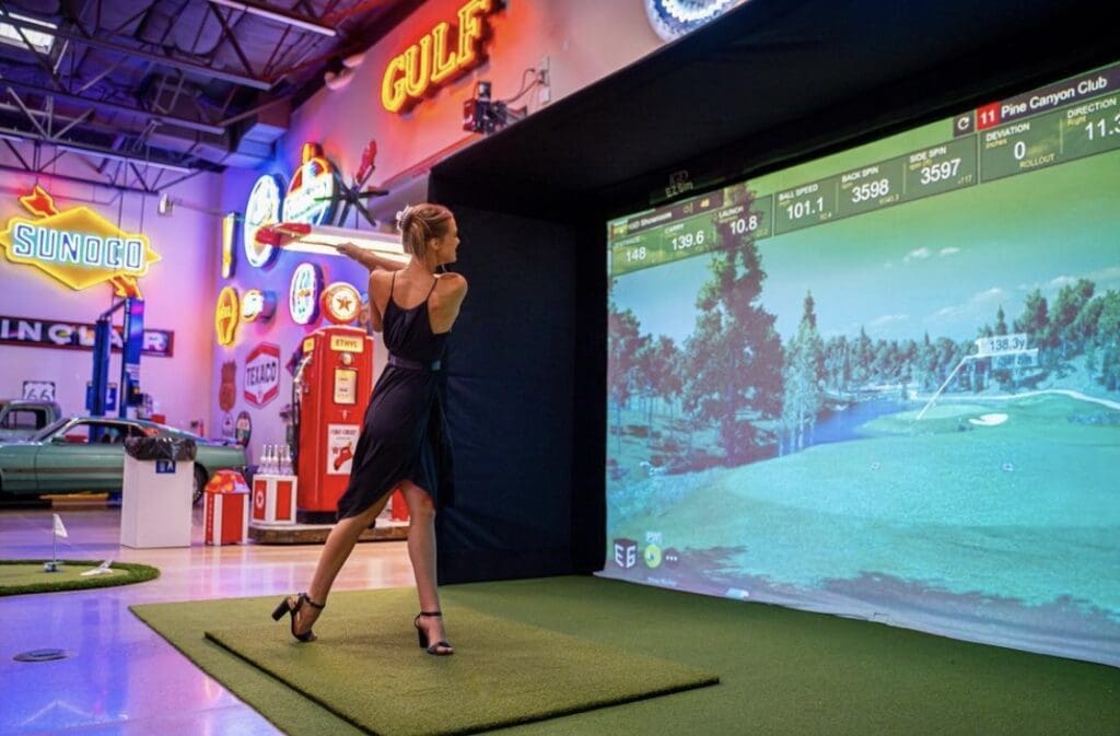 A woman is playing a golf game in a museum.