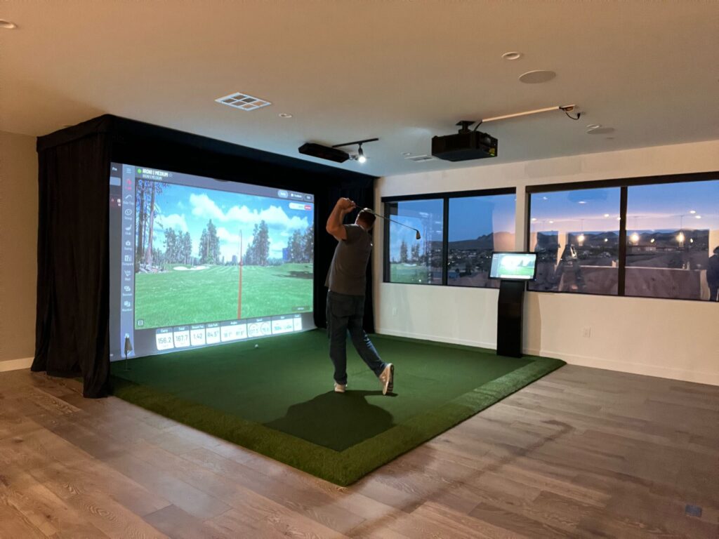 A man playing golf in a room.